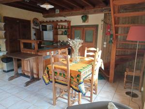a kitchen with a table and chairs in a room at Gites Des Esselards in Yzeron