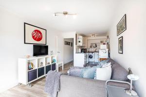 a living room with a couch and a kitchen at Cosy Angel Flat Tube Nearby Stunning Views! in London