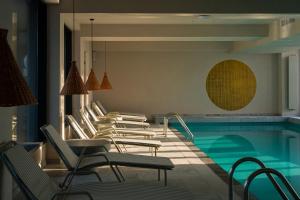 a row of chairs next to a swimming pool at Euforia Retreat and Spa in Eforie Nord