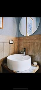 a bathroom with a white sink and two mirrors at Chalet Epinel in Villaret