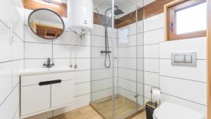 a bathroom with a shower and a sink at Nowodworska, Sun & Snow in Stegna