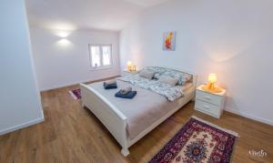 a bedroom with a bed with two pillows on it at Apartment Novax - Free Parking in Mostar