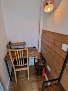a wooden table and chair in a room with a desk at Luxurious Two-Bedroom Suite with Patio & EV power in Greenhithe