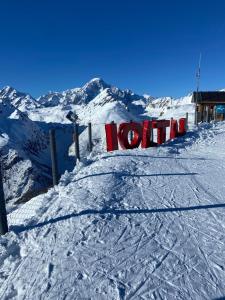 a snow covered mountain with a sign that reads hotel at Chalet Epinel in Villaret