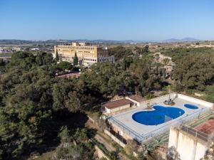 an aerial view of a building with a swimming pool at Costablanca Explore Hostel Sports & Events in La Marina