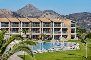 a resort with a pool and mountains in the background at TUI Magic Life Candia Maris - Adults Only in Amoudara Herakliou