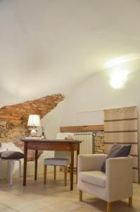 a living room with a table and a chair at DEMIVIE GUESTHOUSE in Lerici