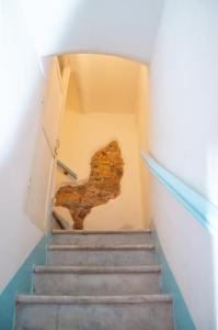 a set of stairs with a door and a wall at DEMIVIE GUESTHOUSE in Lerici