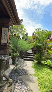 einen Weg, der zu einem Haus mit Treppen und Bäumen führt in der Unterkunft Near Ubud, Batuan Homestay Own King Bed Big Room at Royen Balinese Family Guest House in Sukawati
