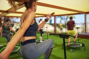a woman sitting on a trampoline in a gym at TUI Magic Life Candia Maris - Adults Only in Amoudara Herakliou