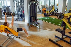 a man is in the gym lifting weights at TUI Magic Life Candia Maris - Adults Only in Amoudara Herakliou