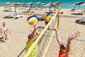 two people playing volley ball on the beach at TUI Magic Life Candia Maris - Adults Only in Amoudara Herakliou