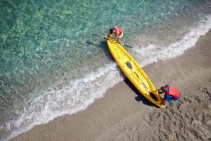 two people in a paddle boat on the beach at TUI Magic Life Candia Maris - Adults Only in Amoudara Herakliou