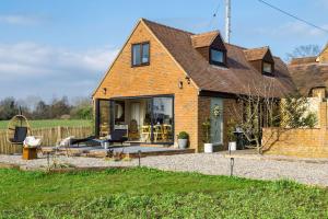 a brick house with a patio in front of it at Herons Nest in Ripple