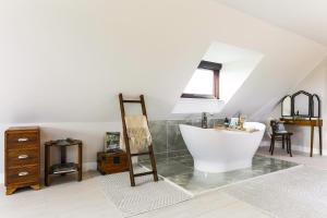 a bathroom with a sink and a bath tub at Herons Nest in Ripple