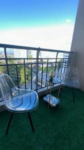two chairs and a table on a balcony at 2BR near BGC & Makati. Karaoke, Netflix, Amazon Prime in Manila