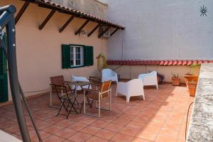 a patio with tables and chairs in a building at Rooftop Madreperla in Taranto
