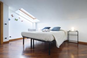 a bedroom with a bed in a white room at Cascina San Marco - Bisulin Apartament in Rosignano Monferrato +23 photos