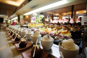 a row of desserts on a buffet line in a restaurant at TUI Magic Life Candia Maris - Adults Only in Amoudara Herakliou