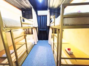a group of bunk beds in a room at Karcof Container Hostel in Senggigi