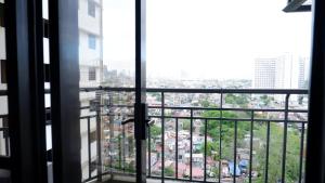 a view of a city from a window at 2BR near BGC & Makati. Karaoke, Netflix, Amazon Prime in Manila