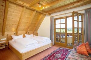 a bedroom with a bed and a large window at Ferienhaus Esche in Hinterzarten