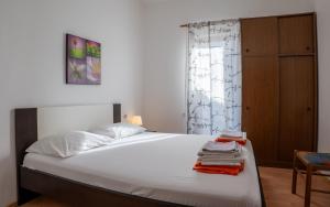 a bedroom with a bed and a dresser at Barba Damir in Pag