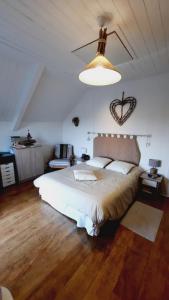 a bedroom with a large bed with a heart on the wall at MAISON MER LA NOE in Saint-Cast-le-Guildo