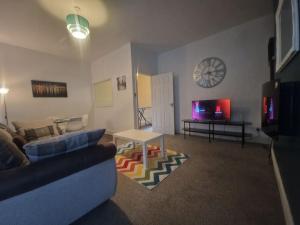 a living room with a couch and a table at Primos Place - 2 Bedroom in Ashington in Ashington
