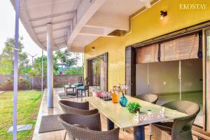 an outdoor dining area with a table and chairs at EKOSTAY- Nest Villa in Karjat