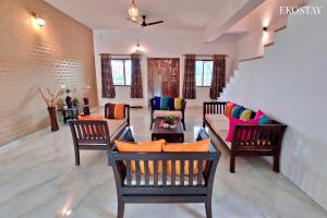 a living room with chairs and a couch at EKOSTAY- Nest Villa in Karjat