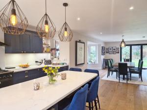 a kitchen and living room with a table and chairs at Squirrels Holt in Chichester