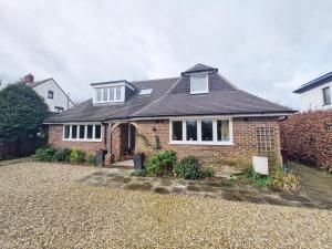 a brick house with a roof at Squirrels Holt in Chichester