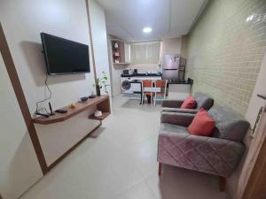 TV a/nebo společenská místnost v ubytování 6 Espaço tranquilo e confortável