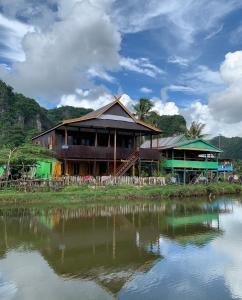 a house sitting next to a body of water at NASRUL HOUSE HOMESTAY FOR BACKPACKERS in Maros