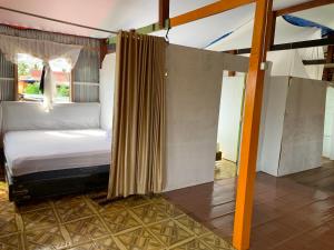 a bedroom with a bed in a room at NASRUL HOUSE HOMESTAY FOR BACKPACKERS in Maros