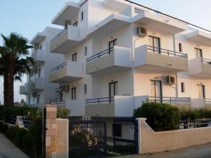 a large white building with a lot of windows at Philippos Studios & Apartments in Kardamaina