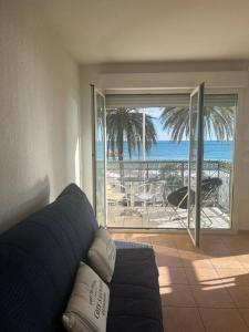 uma sala de estar com um sofá e vista para o oceano em Villa Azzurra superbe 2P centrale et vu mer em Menton