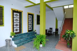 a building with stairs and plants in front of it at Aashray Guestroom 