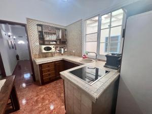a large kitchen with a sink and a window at Aceró Home in Los Llanos de Aridane