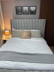 a bedroom with a large bed with a large headboard at Smarthome Serviced Apartment in Nairobi