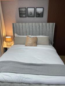 a bedroom with a large bed with a large headboard at Fluted Nest 16th Floor Wood Avenue- Yaya centre Kilimani in Nairobi