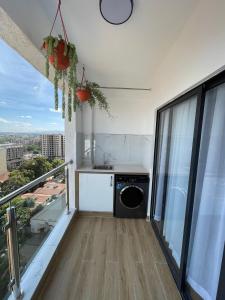 a kitchen with a washing machine on a balcony at Smarthome Serviced Apartment in Nairobi