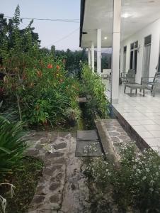 a garden outside of a house with flowers at Hidayah homestay in Kelimutu