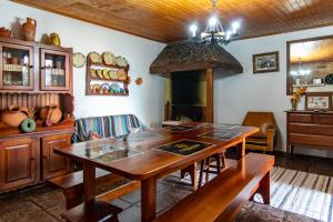 a dining room with a table and a fireplace at Casa da Lena in Batalha