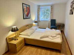 a small bedroom with a bed and a chair at Auszeit im Thierseetal, familienfreundliche Ferienwohnung, FeWo 7 in Thiersee