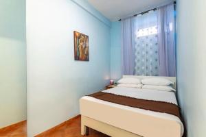 a bedroom with a white bed and a window at Casa Rio in Rome