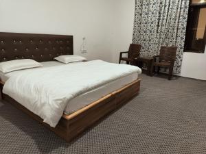 מיטה או מיטות בחדר ב-River Land Guest House