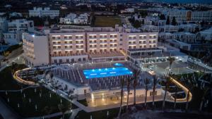 an aerial view of a hotel with a swimming pool at Queens Bay Hotel in Paphos