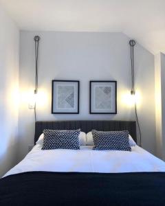 a bedroom with a bed with two lights above it at 'The Kepties' Luxurious Serviced Apartments in Arbroath